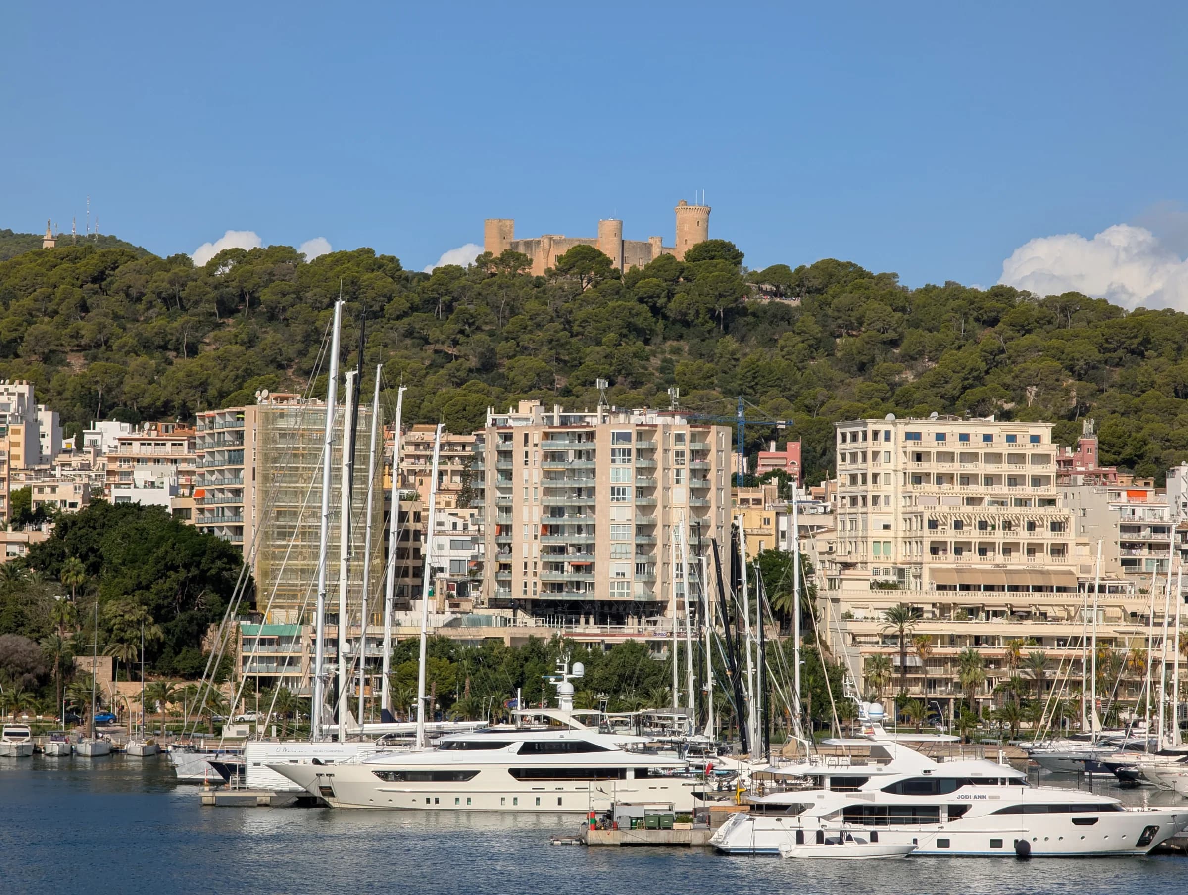 Large yachts moored in Palma beneath Bellver Castle
